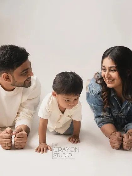 A family lies on the studio floor, creating a sweet and intimate portrait from a unique perspective.
