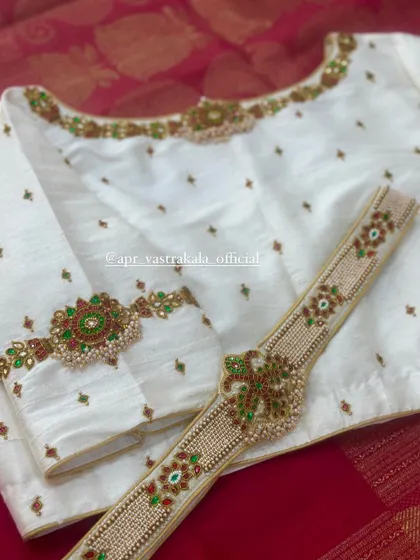 The full view of the off-white blouse, showing the placement of the motifs.