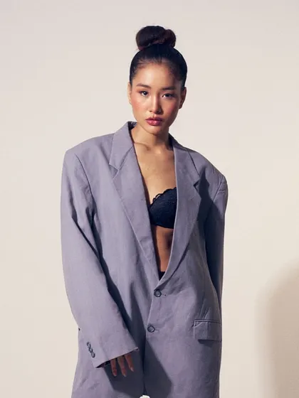 The full look, where the oversized blazer and lace bralette are paired with a fresh, dewy makeup look for a modern, sophisticated vibe.