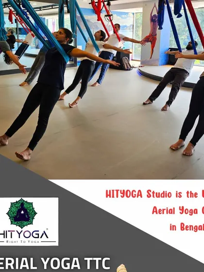 Experience the freedom of aerial yoga in our spacious studio. This group shot shows students exploring anti-gravity asanas, which helps decompress the spine, improve flexibility, and build strength in a fun, dynamic way.