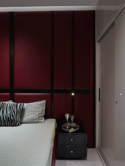 This angle shows the red headboard next to a high-gloss sliding wardrobe, demonstrating a full bedroom solution.