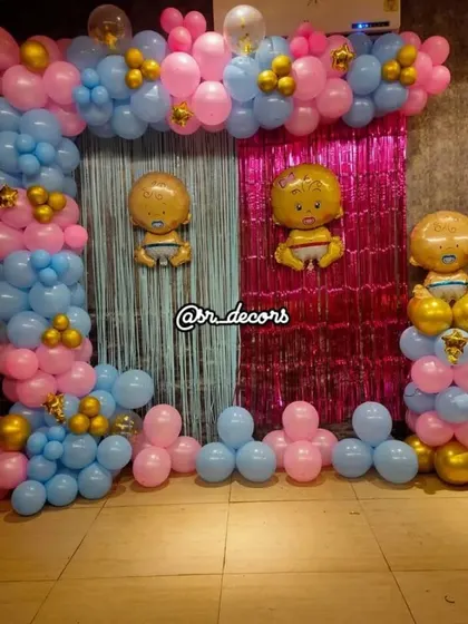 This is a fun setup for a gender reveal party or a baby shower celebrating twins. I use a split backdrop with blue and pink foil curtains and matching balloon arches, complete with baby boy and girl foil balloons to build excitement.