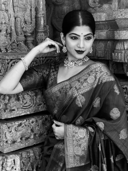 A black and white version of my Kanjivaram saree shoot. The monochrome tones highlight the intricate textures of the saree and the temple carvings, creating a dramatic and timeless portrait.