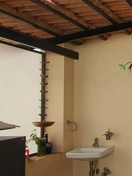 A simple hand-painted bird on a branch in a rustic-style bathroom. Even small artistic touches can add immense character to a space.