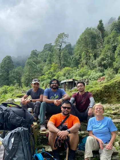 Our trekking group taking a well-deserved break in the misty forests of Nepal.