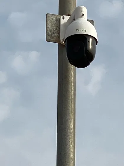 An identical shot of the pole-mounted PTZ camera against a cloudy sky. These cameras are built to withstand all weather conditions.