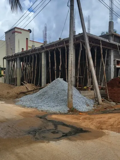 The Hosadurga site with piles of gravel and sand, essential materials for our civil construction work.