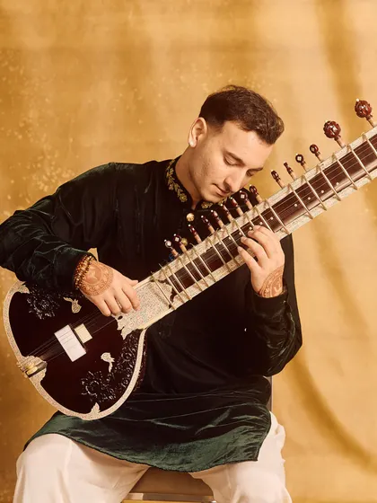 A portrait in a green velvet kurta, showcasing a rich, regal look.