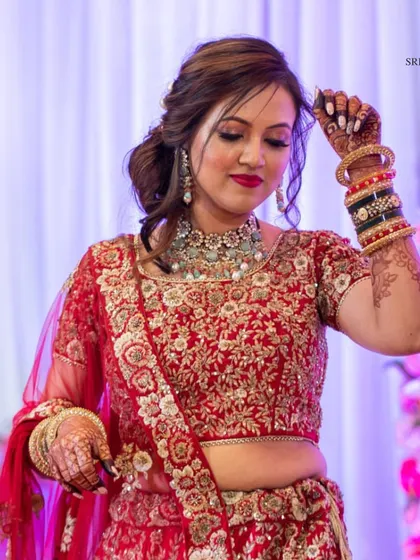 Embracing the timeless elegance of Indian traditions. This beautiful bride from our client diaries looks absolutely graceful in one of our red lehengas.