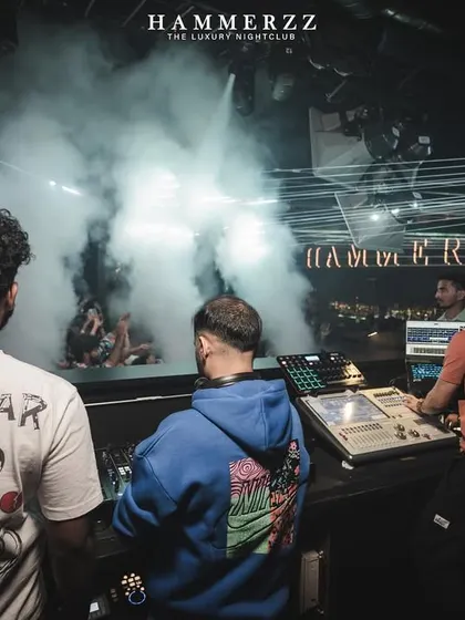 The view from behind the decks as the smoke machines create a thick fog on stage.