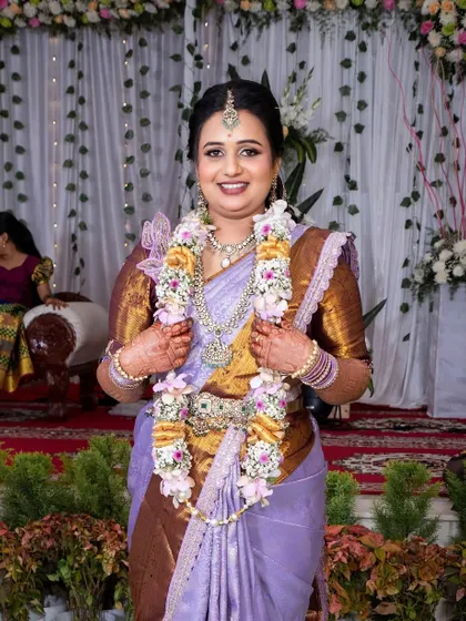 Pretty Bhavya on her engagement day. Her lavender saree and diamond jewelry are complemented by a soft and radiant makeup look.