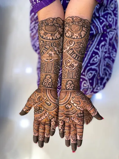 A beautiful bridal mehendi for a happy client. The design is a mix of peacocks, paisleys, and other traditional Indian motifs, creating a full and festive look.