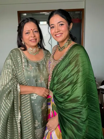 A classic portrait of the bride and her mom, both looking elegant and ready for the Mehndi ceremony.