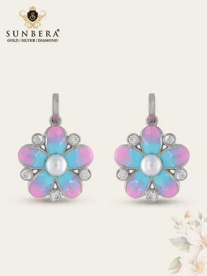 These charming silver earrings feature a flower design with vibrant pink and blue enamel and a pearl center. They are a playful and colourful addition to our silver collection.