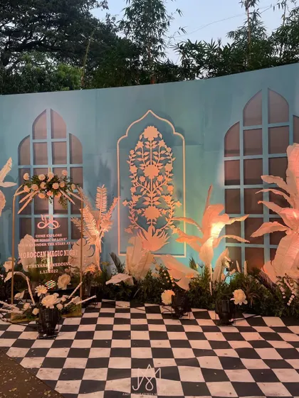 A full view of the Moroccan-inspired photo booth, featuring a checkered floor, blue and white patterned walls, and artistic lighting.