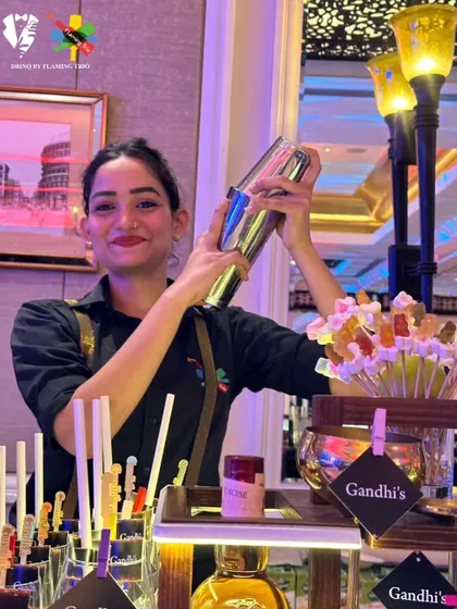 Our mixologist shaking up a cocktail at a fun, candy-themed bar.