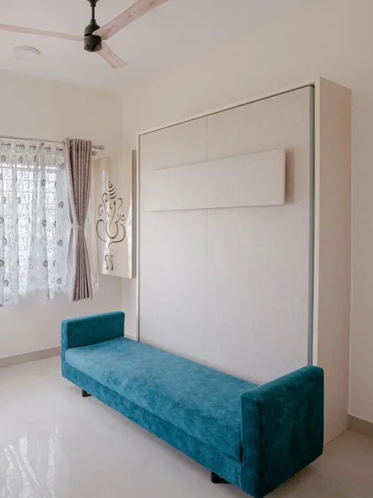 Here is the same Murphy bed, folded away to reveal a comfortable and chic blue sofa. This is how we create multifunctional spaces that work for you day and night.