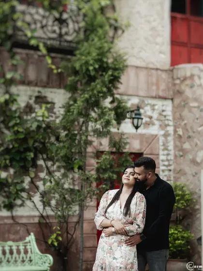 A relaxed and intimate portrait in a rustic courtyard setting. This shows a softer, more serene side of an urban shoot, focusing on a quiet moment of togetherness.