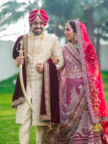A candid moment of pure happiness between a beautiful Sikh couple. We believe the best shots are the unposed ones, capturing the genuine smiles and laughter that make your wedding day unique. This photo reflects our classic and vibrant wedding photography style.