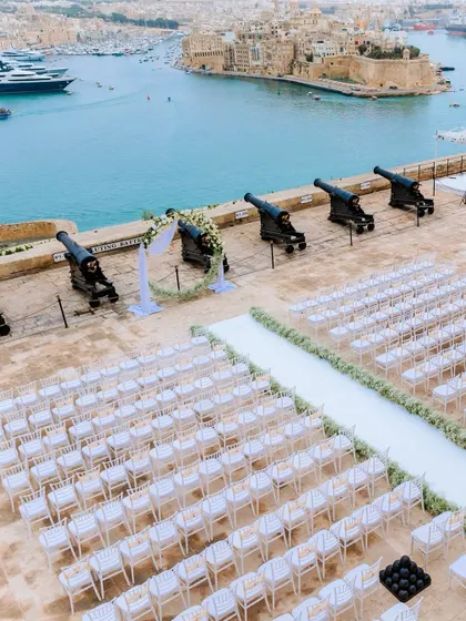 A stunning white wedding ceremony set up at the historic Saluting Battery in Malta, overlooking the Grand Harbour. We transformed this unique venue into an elegant and intimate space for the couple to exchange their vows.
