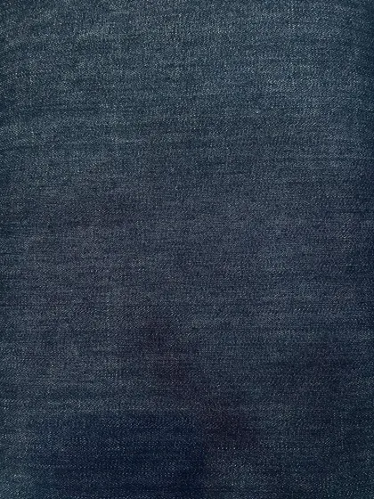 A subtly faded dark denim. This fabric provides a softer look than raw denim while still maintaining a deep blue color.
