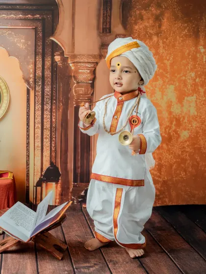 Another angle of the baby playing with the cymbals, showing his engagement with the musical props.