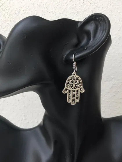 The Hamsa hand is a symbol of protection, and I've made it into this beautiful drop earring. It's a meaningful and stylish piece, available in both silver and antique gold tones.
