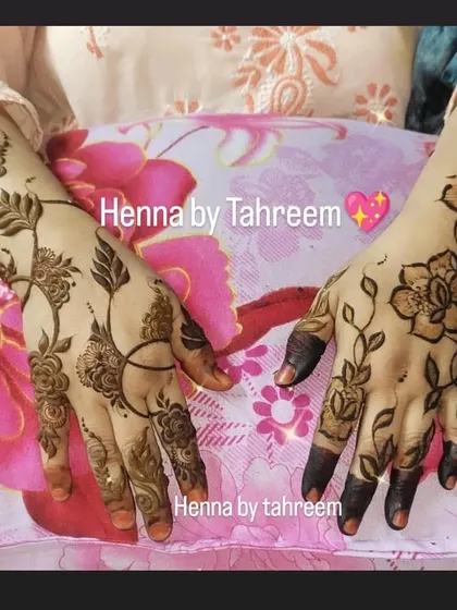 A lovely pair of hands showing two different but complementary minimal designs. One is a floral vine, and the other is a more abstract leafy pattern, showing how guests can choose different styles.