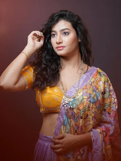 A close-up on the model's expression, showing the beautiful detail of the yellow blouse and her thoughtful gaze.