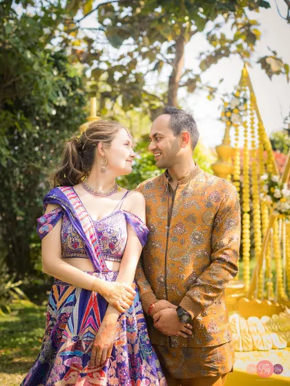 A classic couple portrait from Nelya and Tirath's Haldi. Their coordinated outfits and happy smiles make this a cherished memory.