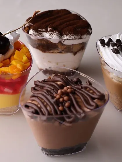Our dessert cups are a popular choice for Rakhi gifting. This image shows a variety of our single serving desserts, including mango custard, tiramisu, banoffee pie, and hazelnut mousse.