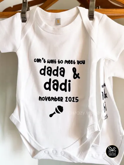 "Can't wait to meet you Dada & Dadi." We personalize baby onesies with sweet messages for every member of the family, making them a core part of our announcement hampers.