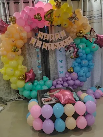 The full view of the rainbow unicorn balloon arch, designed to create a magical photo corner at home.