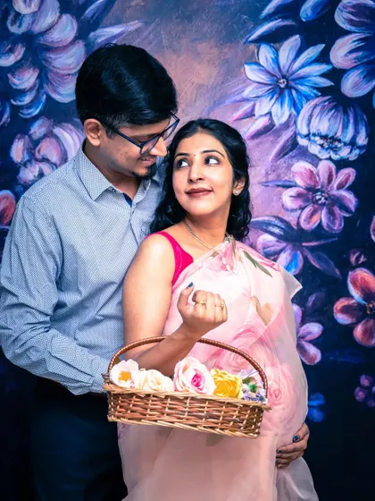 My studio can be transformed with different backdrops. This painted floral background adds a touch of artistic flair and color to this lovely indoor maternity portrait.