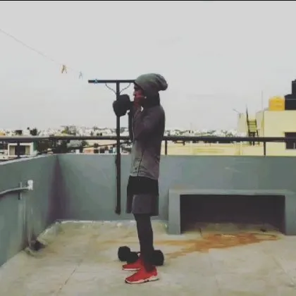 A student holding dumbbells at shoulder height, ready for a set of presses. This is a great way to build explosive power.