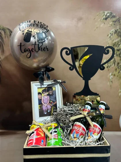 Celebrate his first Father's Day with this special hamper. It includes a "Best Dad" trophy, a personalized photo frame, a "Our First Father's Day" balloon, and his favorite snacks and drinks.