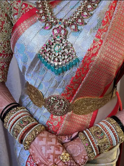 A close-up of the bride's stunning jewellery against the backdrop of her beautifully draped saree.