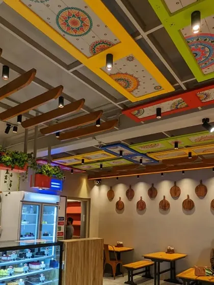 This was a special commissioned project for a cafe. I hand-painted mandala designs on multiple ceiling panels, which were then framed in bright colors. Seeing my art integrated into a public space like this was incredibly rewarding.
