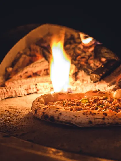 The heat from our wood-fired oven is what gives our Neapolitan pizza its authentic character.