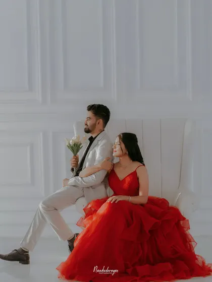 Another angle of the elegant couple on the white chair, showcasing a different but equally sophisticated pose.