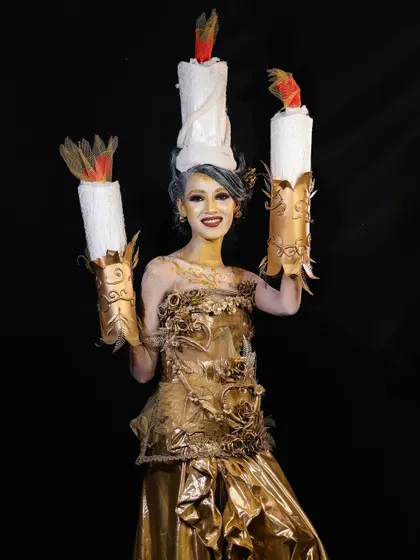 A full-length shot of the candle character, smiling and showing off the complete, imaginative creation.
