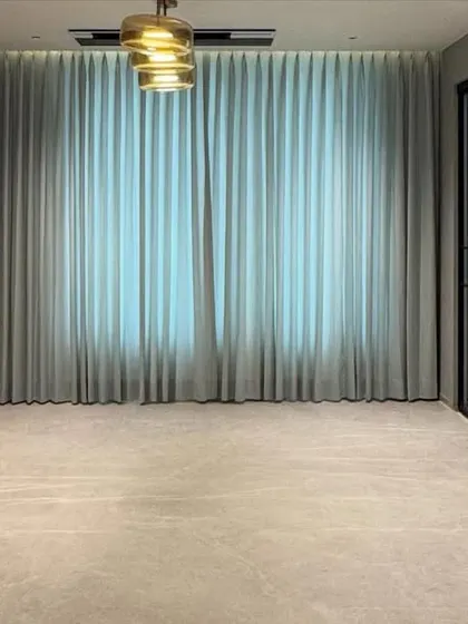 A wide shot of a custom storage unit in a penthouse project. The design includes both closed cabinets for storage and open sections with a marble backsplash, blending functionality with high-end finishes.