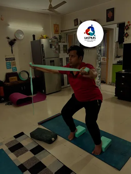 Using a resistance band and blocks, a client works on his squat form and mobility.