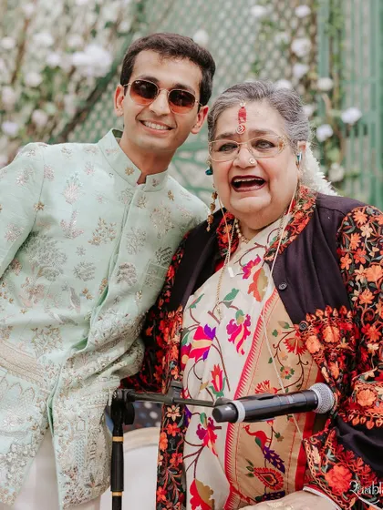 The groom sharing a joyful moment with legendary singer Usha Uthup, who performed at the wedding. A memorable snapshot from the ELLE India feature.