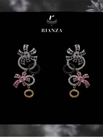 Whimsical and modern, these earrings feature a bow design crafted with blue sapphires, rubies, and diamonds. They are perfect for a bride who wants a touch of playful elegance.