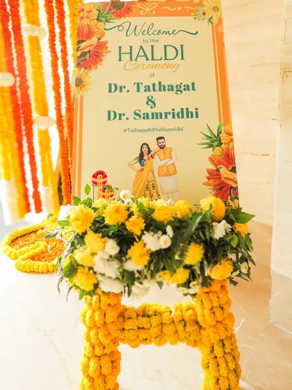 The personalized welcome sign for the Haldi ceremony of Dr. Tathagat & Dr. Samridhi, adorned with marigolds.