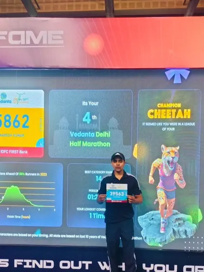 Holding up my bib number in front of my race stats. The data shows the result of dedicated training.