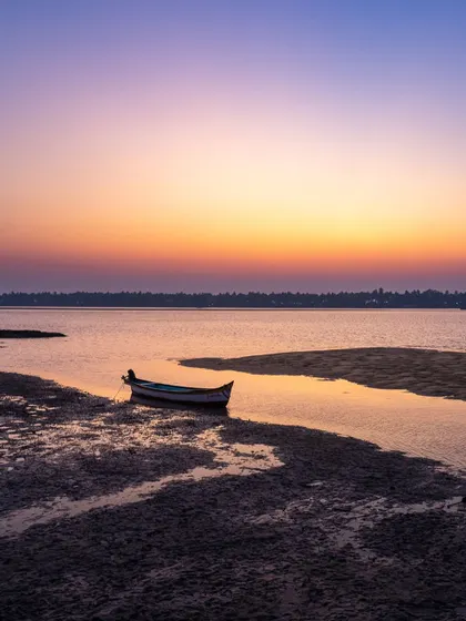 A lone boat rests on the shore during a beautiful sunset in Brahmavara. Life by the coast offers many insights, and the free therapy of "Vitamin Sea" is available to anyone with the time.