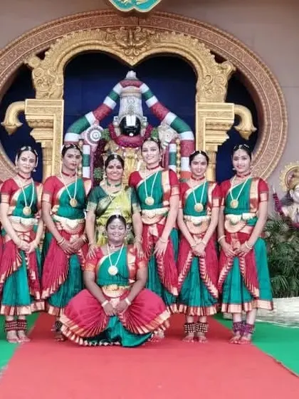 The full team of my girls who performed at Tirumala, posing with me before the magnificent temple backdrop. It was a day of devotion, dance, and unforgettable memories.