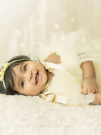A big, joyful laugh. This photo perfectly captures the happiness and fun of a 6-month milestone session.